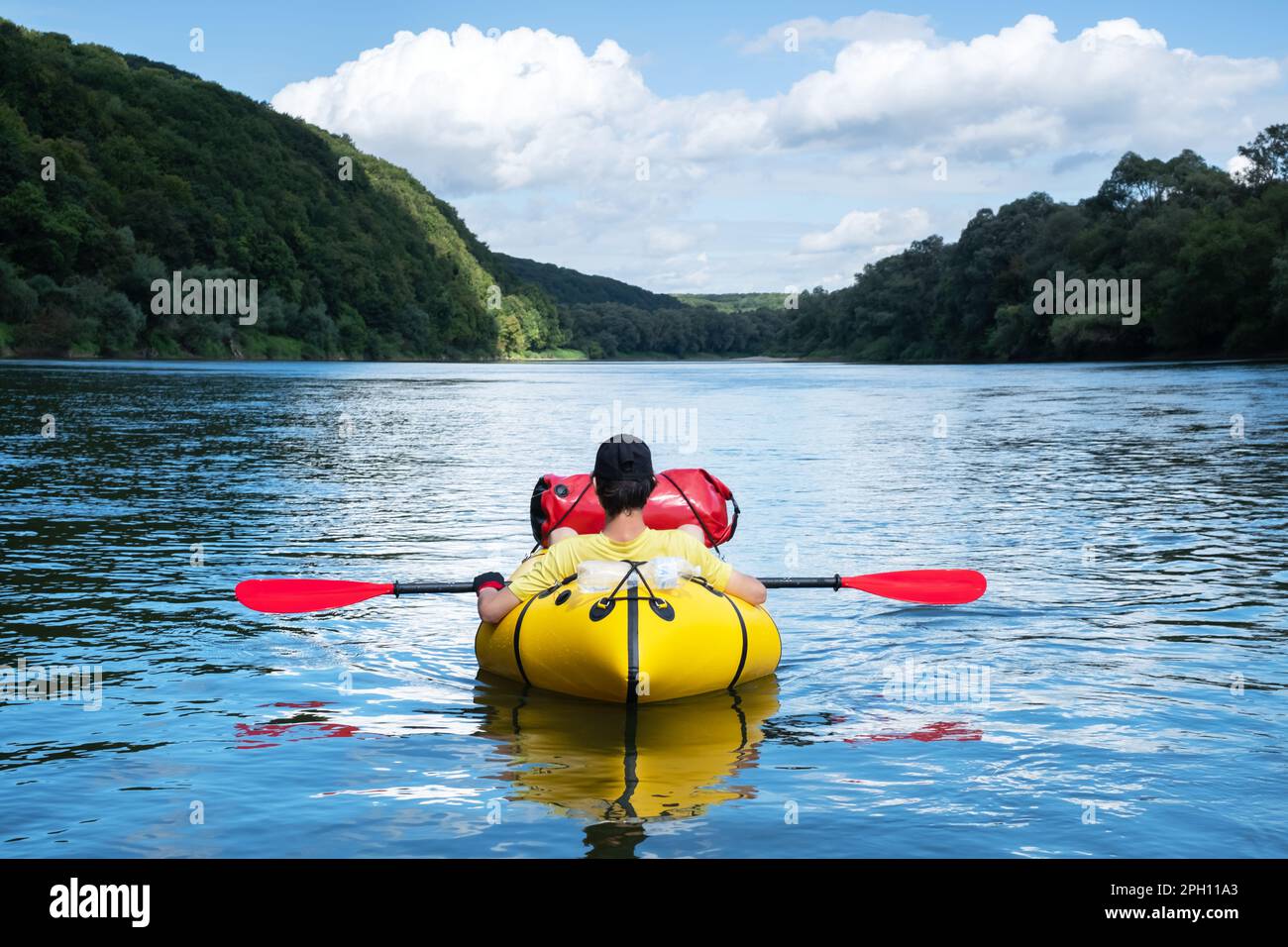 Tourist on yellow packraft boat on sunrise Dnister river in Ukraine. Packrafting. Active lifestile concept Stock Photo