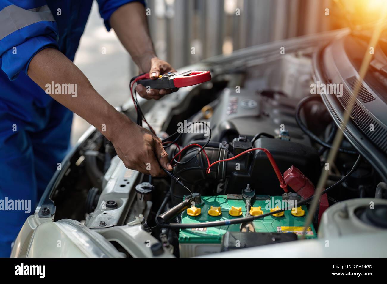 Close up technician uses multimeter voltmeter to check voltage level in