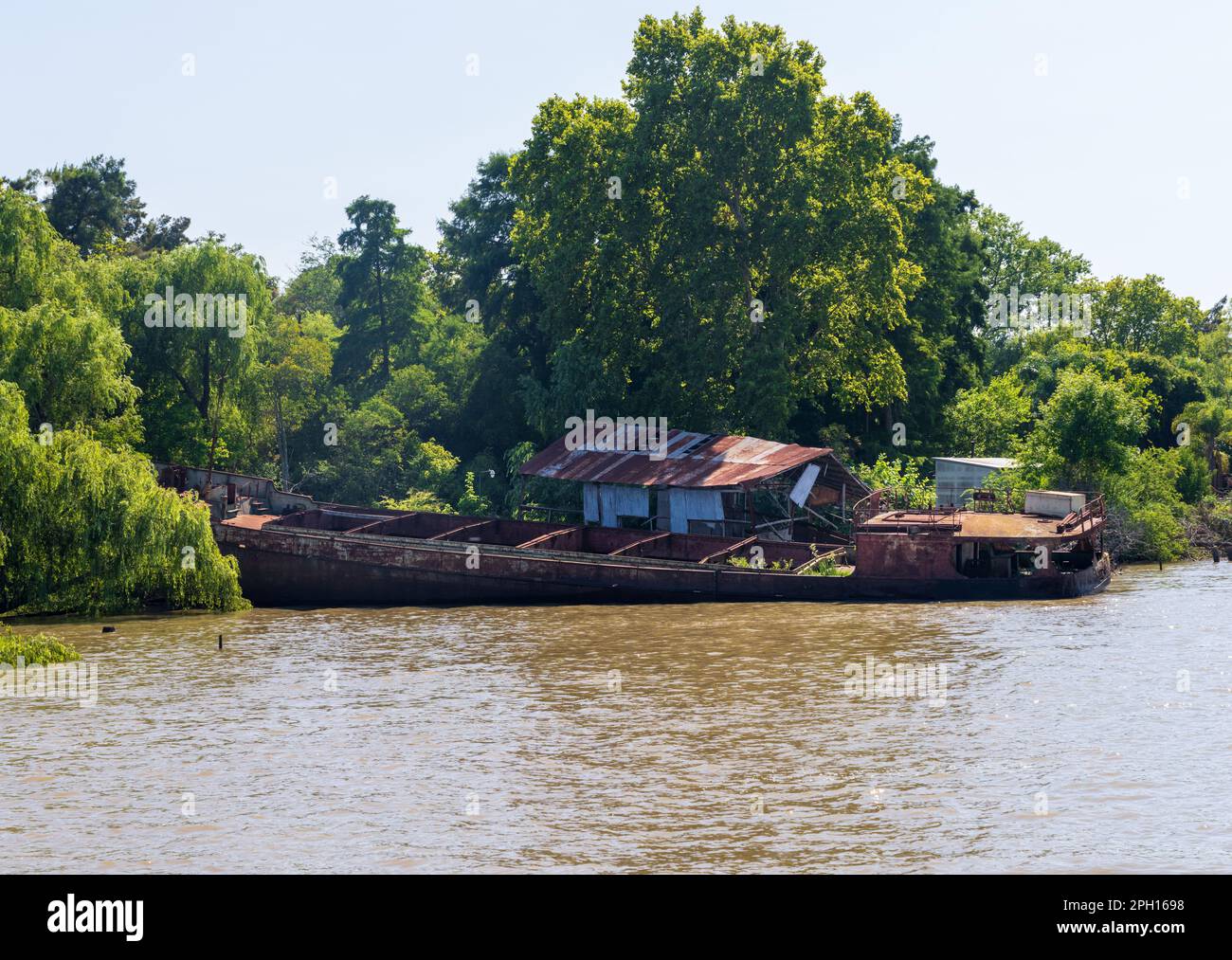 Abandoned and rotting tour or cruise boat on banks of Parana delta near Tigre Argentina Stock Photo