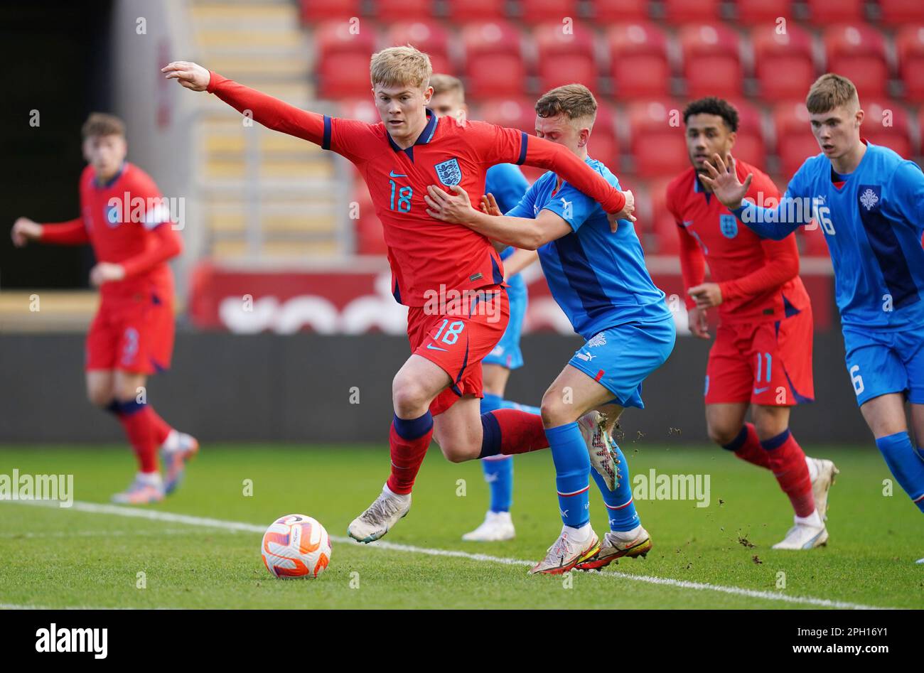 England U19's Lewis Hall (left) and Iceland U19's Eggert Aron Gudmundsson battle for the ball during the UEFA U19 European Championship 2023 Group G qualifying match at the AESSEAL New York Stadium, Rotherham. Picture date: Saturday March 25, 2023. Stock Photo