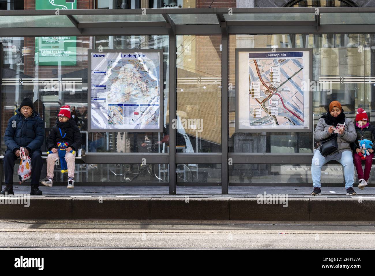 AMSTERDAM - Travelers wait for the tram in the center of Amsterdam. Public transport in the capital is being overhauled because the number of travelers has decreased due to the corona crisis. ANP EVERT ELZINGA netherlands out - belgium out Stock Photo