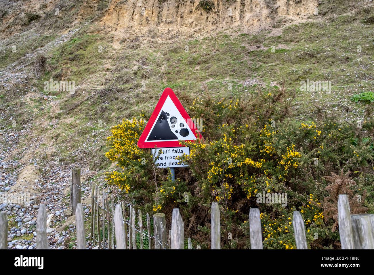 Cliff erosion sign warning beach goers of the dangers on Dunwich beach Stock Photo