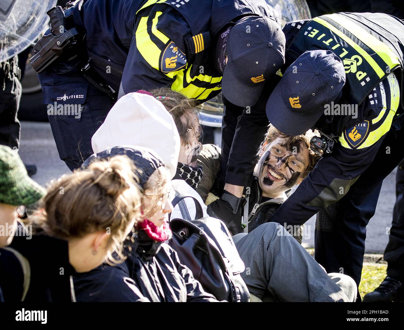 Eindhoven, Netherlands. 25th Mar 2023. EINDHOVEN - A climate activist from Extinction Rebellion is arrested during an action at Eindhoven Airport. The activists are very concerned about the damage that air traffic causes to the climate. ANP SEM VAN DER WAL netherlands out - belgium out Credit: ANP/Alamy Live News Stock Photo