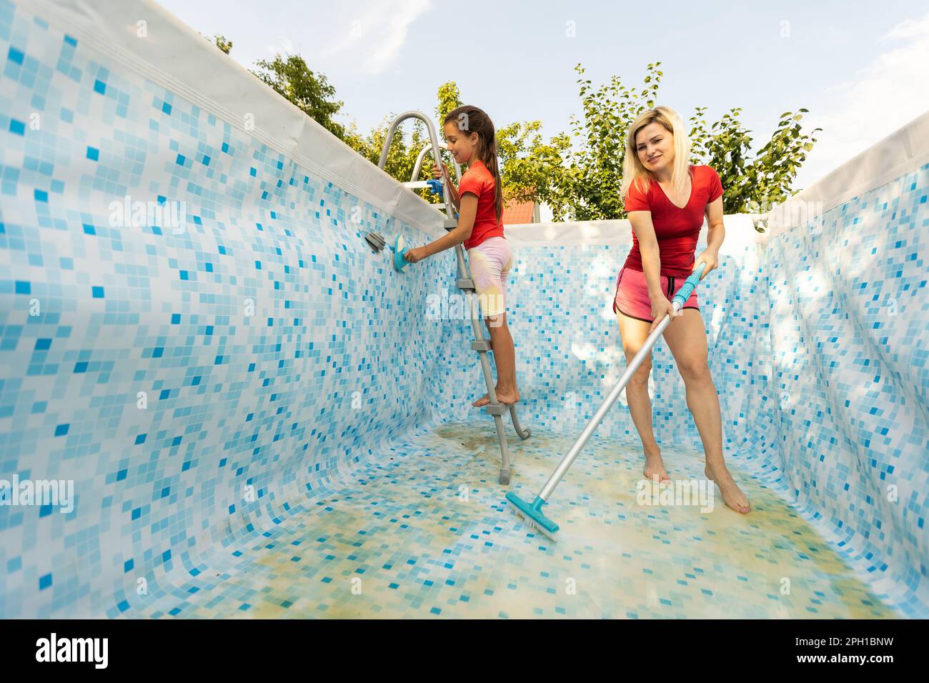 Back yard swimming pool behind modern single family home at pool