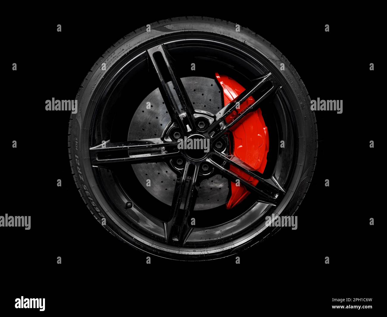 Car alloy wheel and tyre isolated on black background. New alloy wheel