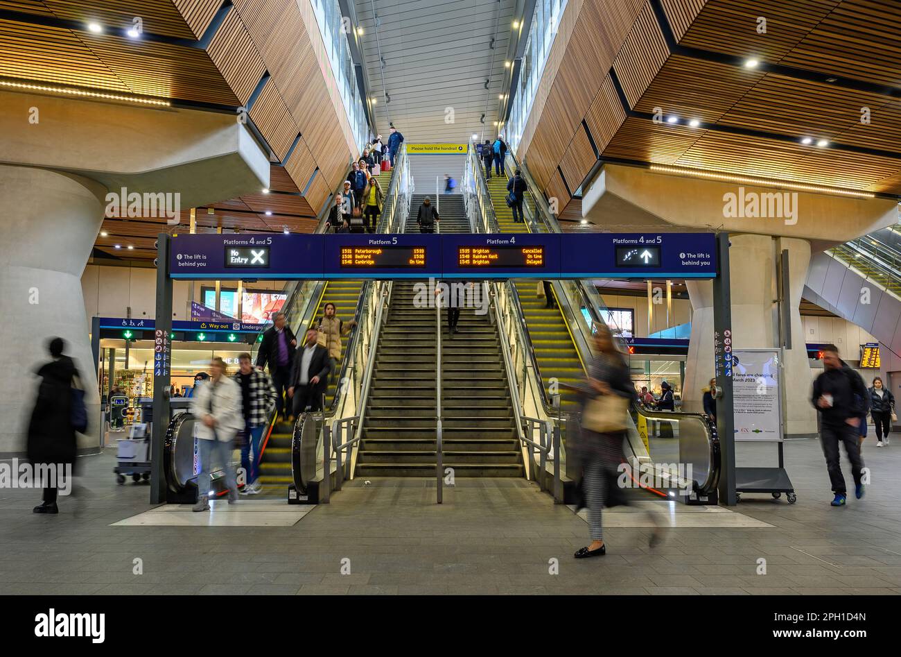 London, UK: People in London Bridge railway station with motion blur. Station concourse with 