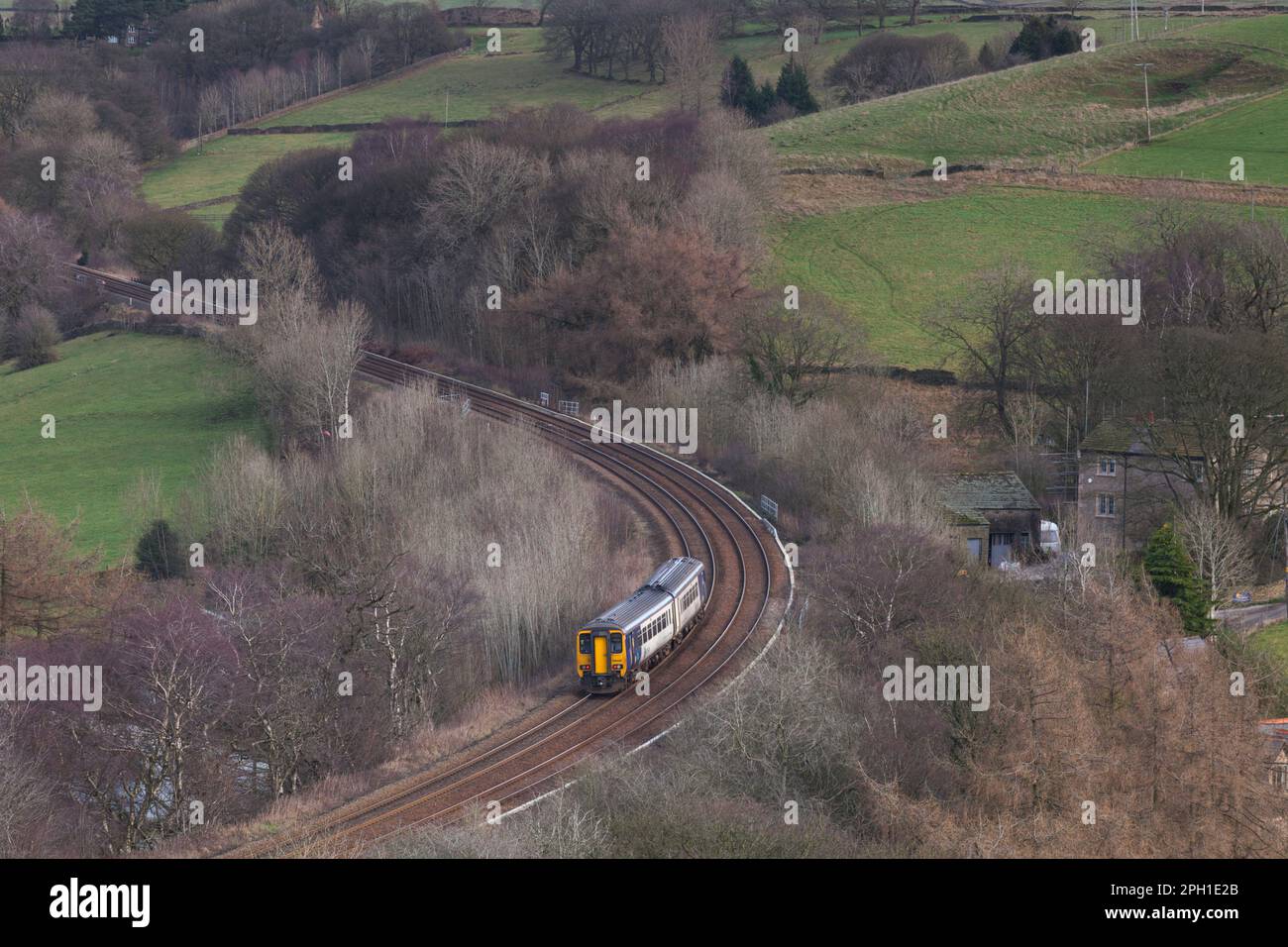 Northern Rail class 156 DMU train in the Derbyshire countryside passing