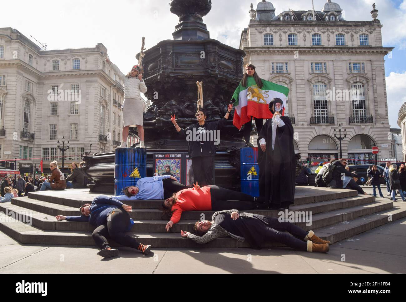 London, UK. 25th March 2023. Iranian protesters stage a 'die-in'. Iranian and Ukrainian women organised a joint protest in Piccadilly Circus, calling for freedom in Iran and an end to Russian attacks in Ukraine. Credit: Vuk Valcic/Alamy Live News Stock Photo
