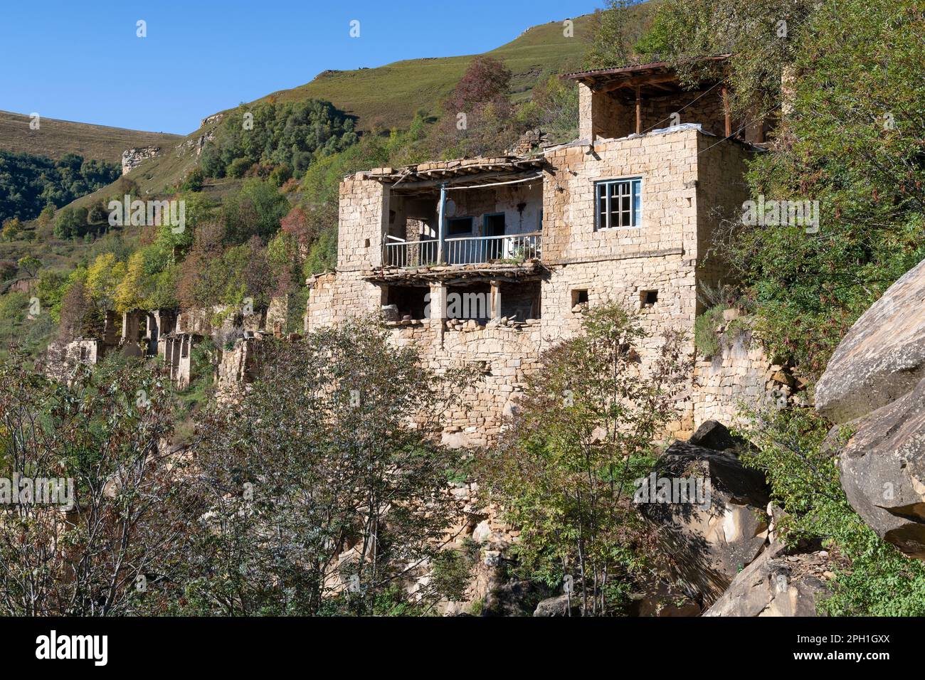Old traditional mountain house in the abandoned village of Gamsutl on a September afternoon. Dagestan, Russian Federation Stock Photo