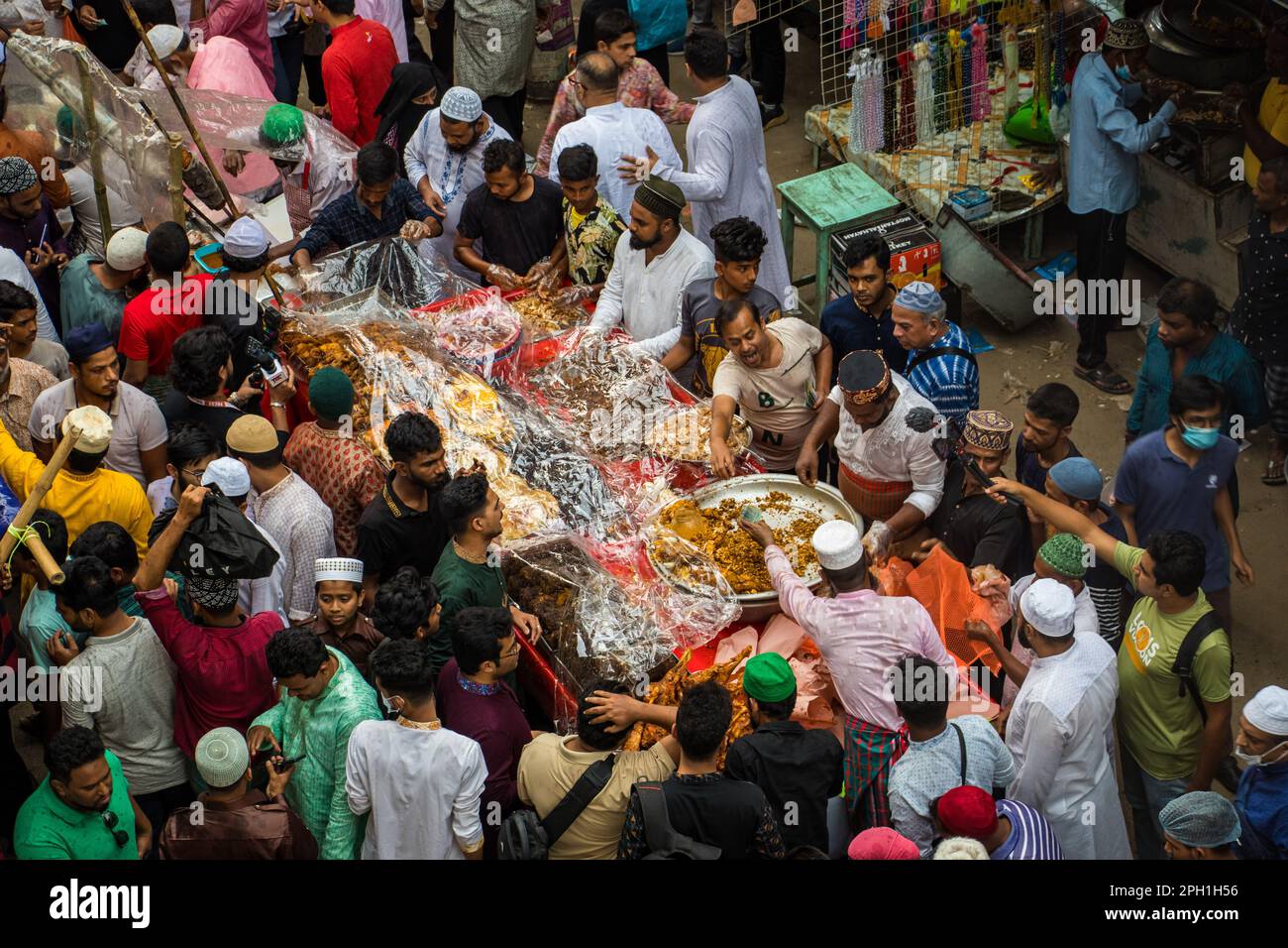 Bangladesh. 24th Mar, 2023. Bangladeshi vendors sell Iftar's items at Chawkbazar on the first day of the Muslim holy month of Ramadan. Every year a traditional Iftar market is open on this occasion for almost 400 years in Old Dhaka. (Photo by Md. Noor Hossain/Pacific Press) Credit: Pacific Press Media Production Corp./Alamy Live News Stock Photo
