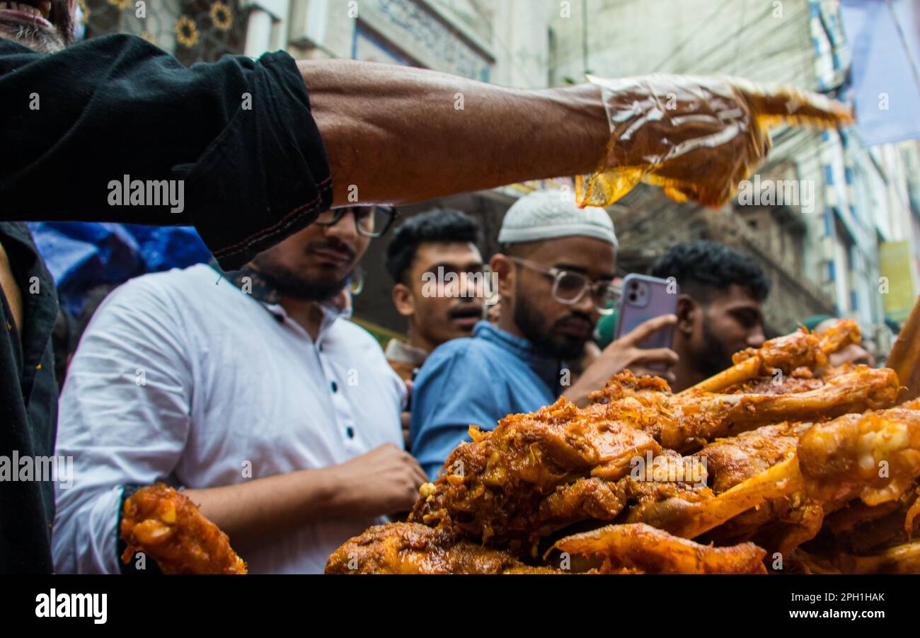 Bangladesh. 24th Mar, 2023. Bangladeshi vendors sell Iftar's items at Chawkbazar on the first day of the Muslim holy month of Ramadan. Every year a traditional Iftar market is open on this occasion for almost 400 years in Old Dhaka. (Photo by Md. Noor Hossain/Pacific Press) Credit: Pacific Press Media Production Corp./Alamy Live News Stock Photo