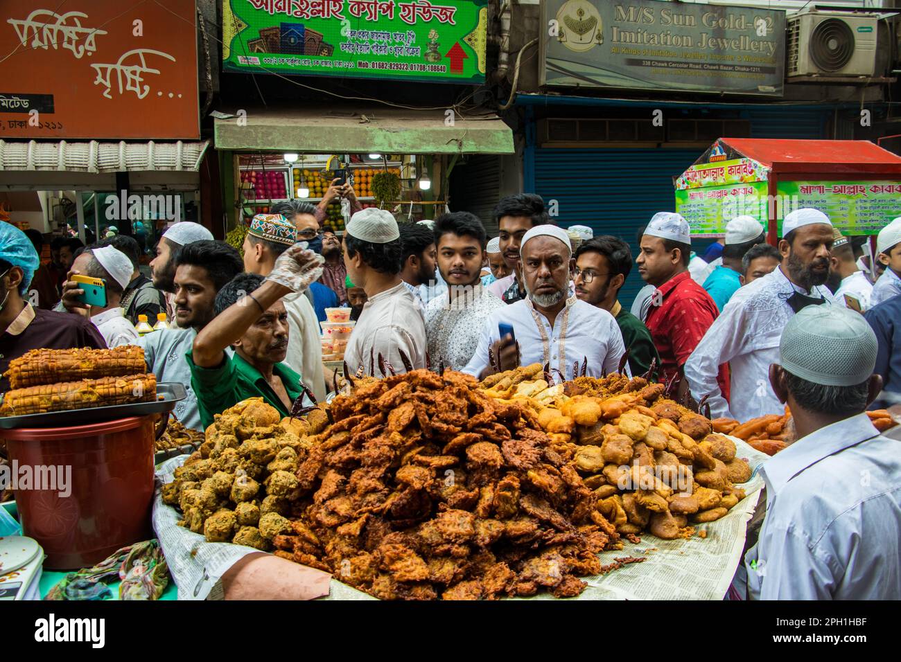 Bangladesh. 24th Mar, 2023. Bangladeshi vendors sell Iftar's items at Chawkbazar on the first day of the Muslim holy month of Ramadan. Every year a traditional Iftar market is open on this occasion for almost 400 years in Old Dhaka. (Photo by Md. Noor Hossain/Pacific Press) Credit: Pacific Press Media Production Corp./Alamy Live News Stock Photo