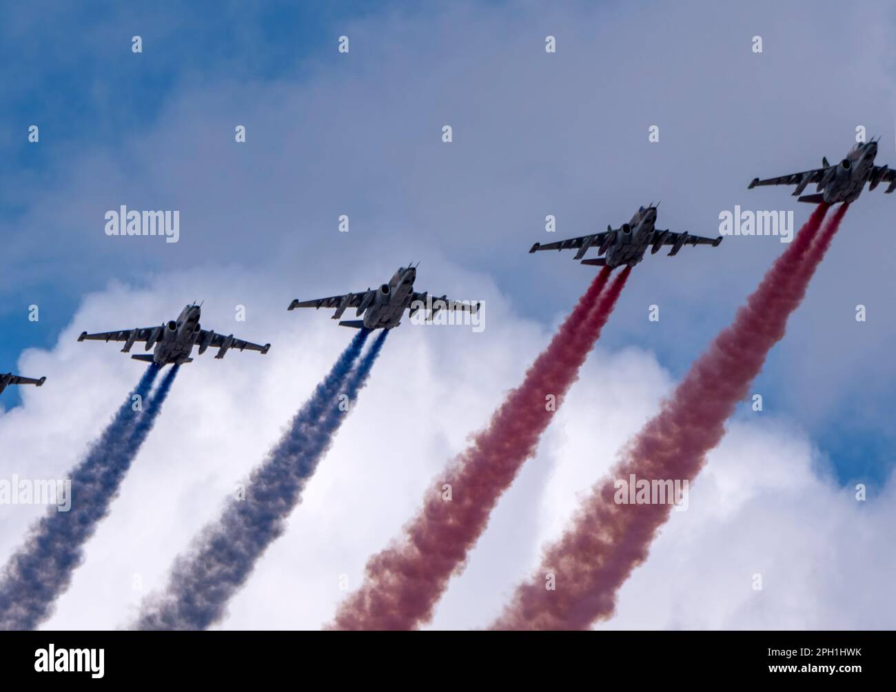 MOSCOW, RUSSIA - MAY 7, 2022: Avia parade in Moscow. Group of Russian fighters Sukhoi Su-25 with painted russian flag in the sky on parade of Victory Stock Photo