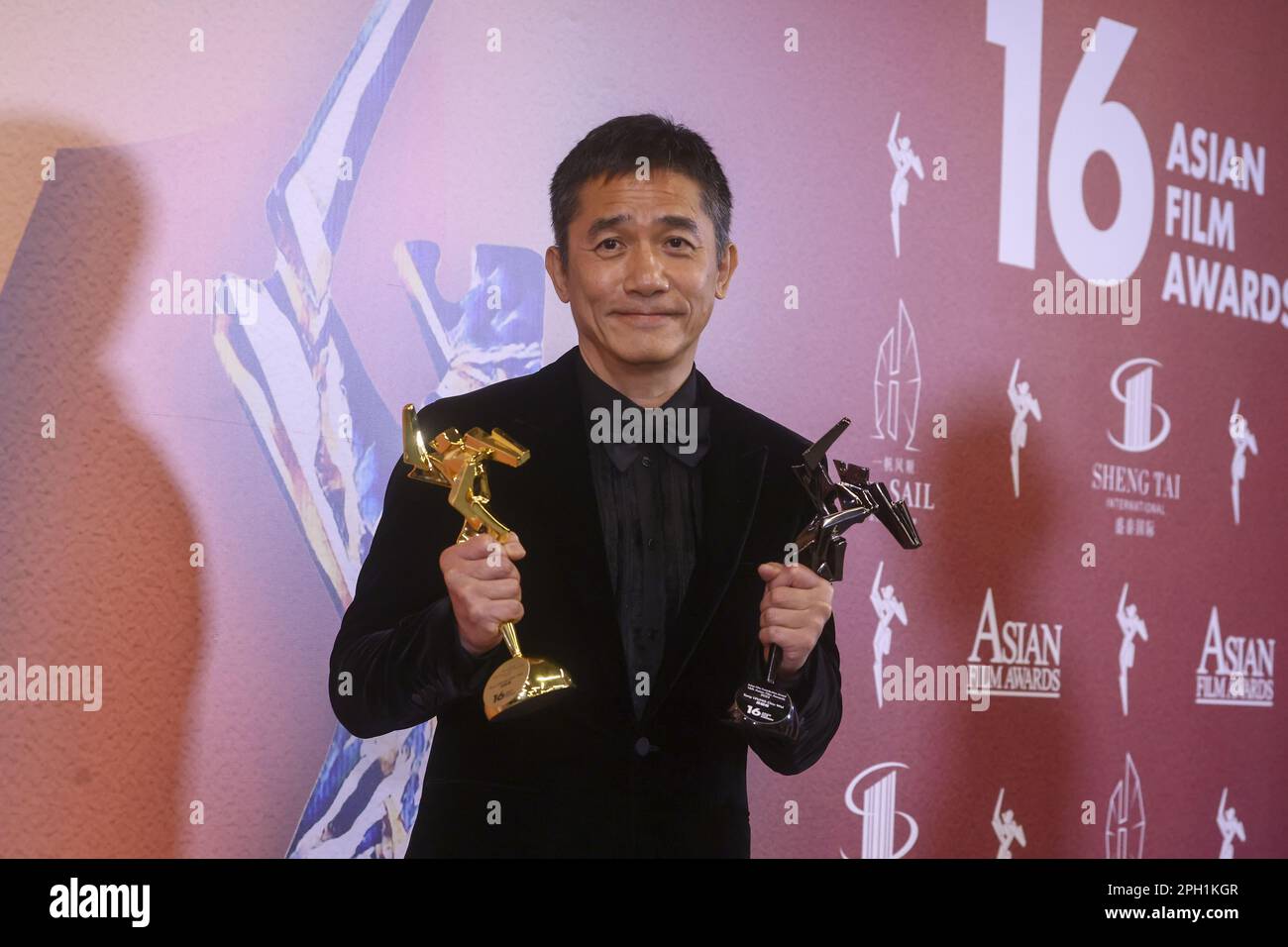Tony Leung Chiu-wai poses with his award after winning the Best Actor with 'Where the Wind Blows', at the 16th Asian Film Awards at Hong Kong Palace Museum, in Hong Kong 12MAR23. SCMP/ Dickson Lee Stock Photo