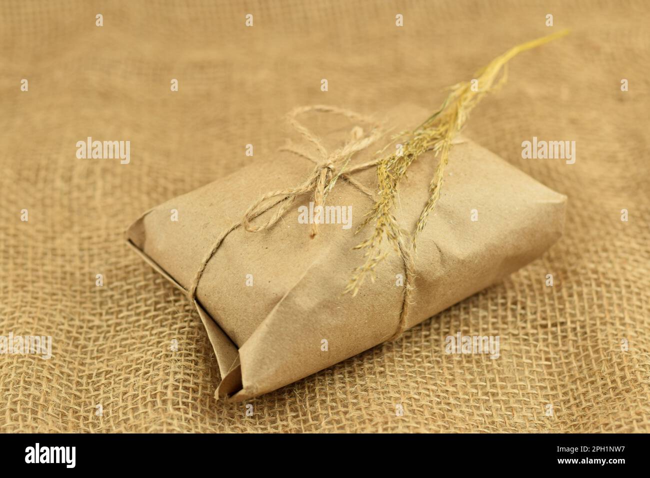 Simple eco friendly gift boxes package wrap with brown paper. Burlap