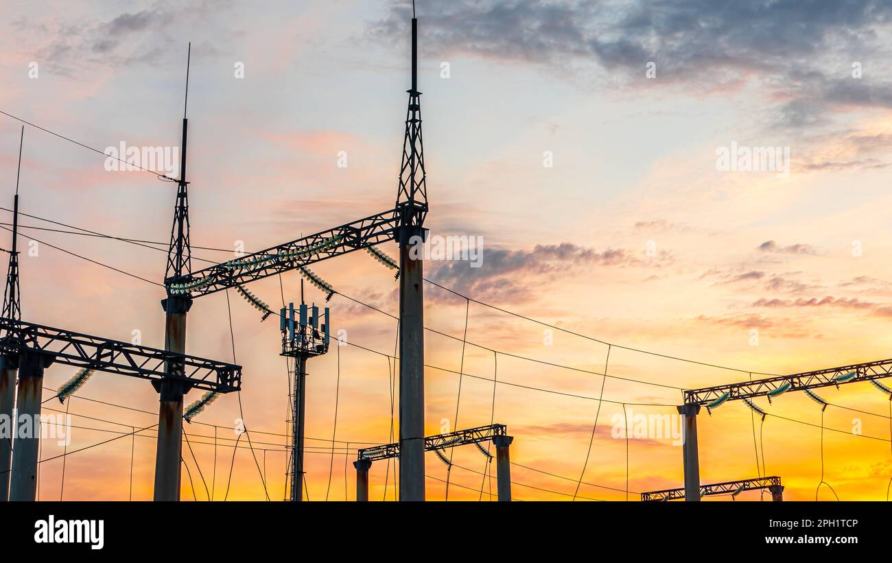 Production of fuel and electricity.Electrical networks with wires and transformers at sunset.Power transmission lines and from the power plant.Power l Stock Photo