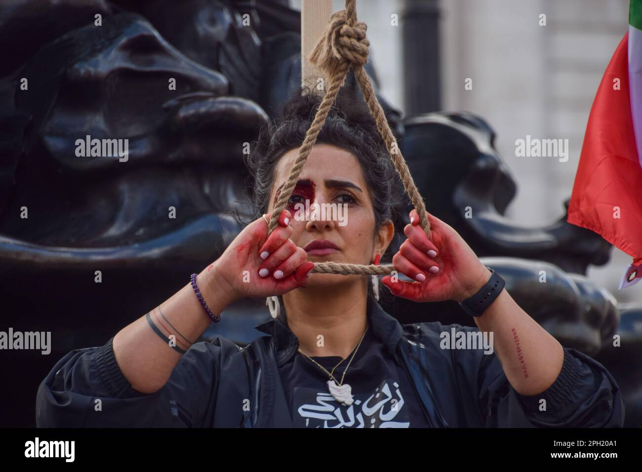 London, UK. 25th March 2023. A woman protests against executions in Iran. Iranian and Ukrainian women organised a joint protest in Piccadilly Circus, calling for freedom in Iran and an end to Russian attacks in Ukraine. Credit: Vuk Valcic/Alamy Live News Stock Photo
