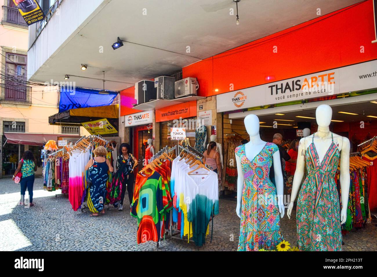 Rio de Janeiro, Brazil - January 3, 2023: People browsing merchandise in sidewalk retail display Stock Photo
