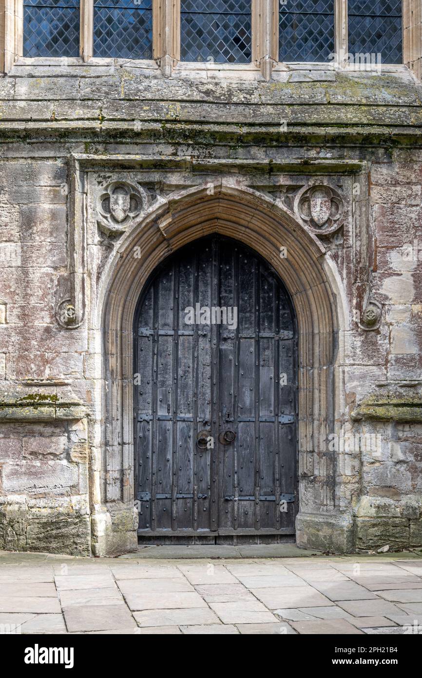 The west door of the medieval church of St. John in Cirencester, England Stock Photo