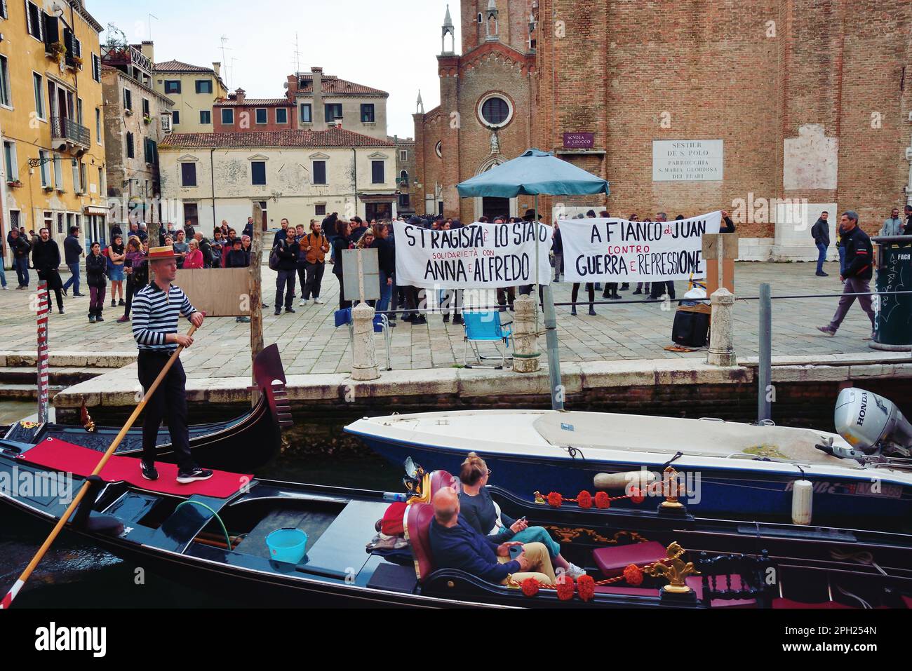 Venice, Italy. 25th Mar, 2023. 2000 policemen, closed shops, closed bridges and checking of the documents of passers-by, Campo dei Frari off limits, to contain an unauthorized demonstration of 500 anarchists. The peaceful marchers protest against the NATO war and in support of the jailed anarchists Juan Antonio Sorroche Fernandez and Alfredo Cospito and ask for the abolition of special detention as per article of law “41 bis”. Many slogans proclaim that “the time has come to do as in France”. Venice, Italy. March 25th, 2023. Credit: Ferdinando Piezzi/Alamy Live News Stock Photo