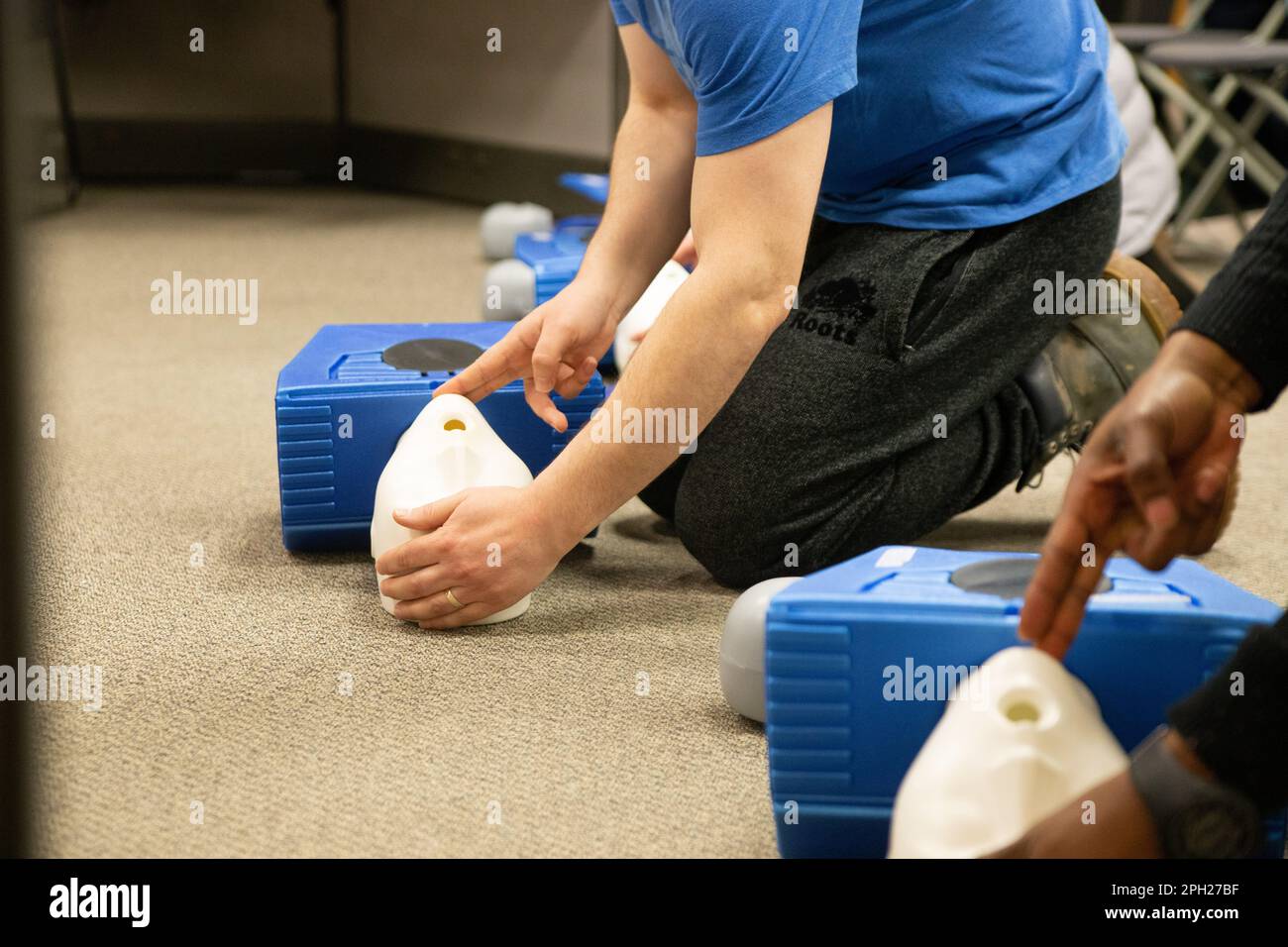 CPR training class by security guard in office Stock Photo