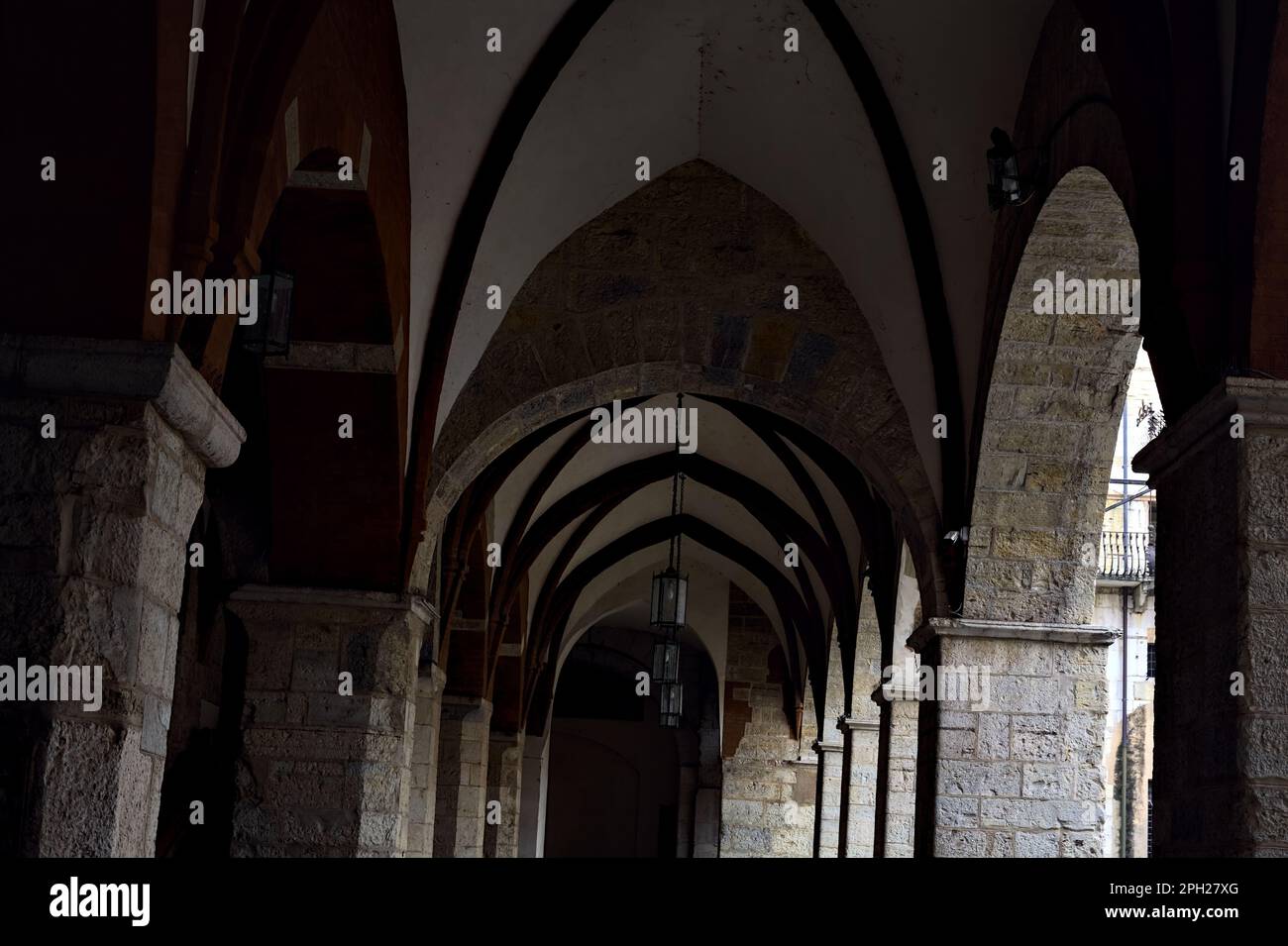 Porch partly in the shade of a historical building in an italian city