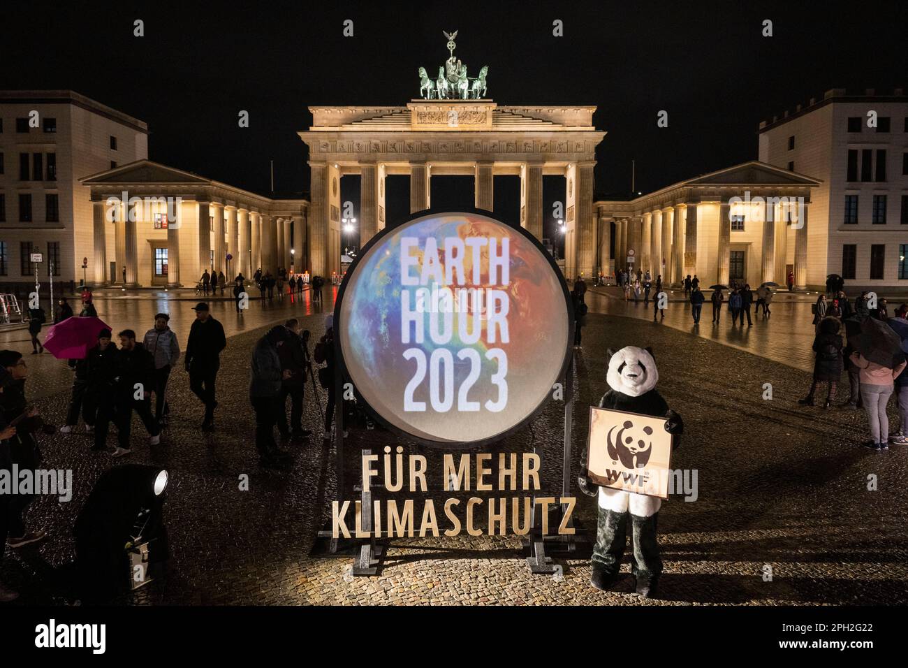 Berlin, International. 25th Mar, 2023. The lighting of the Brandenburg Gate is still switched on shortly before the start of the 'Earth Hour' campaign. With the 'Earth Hour', the environmental protection organization World Wide Fund For Nature (WWF) wants to set an example for climate and environmental protection. Numerous cities around the world are taking part in the campaign and switching off the lights at landmarks for an hour. Credit: Christophe Gateau/dpa/Alamy Live News Stock Photo