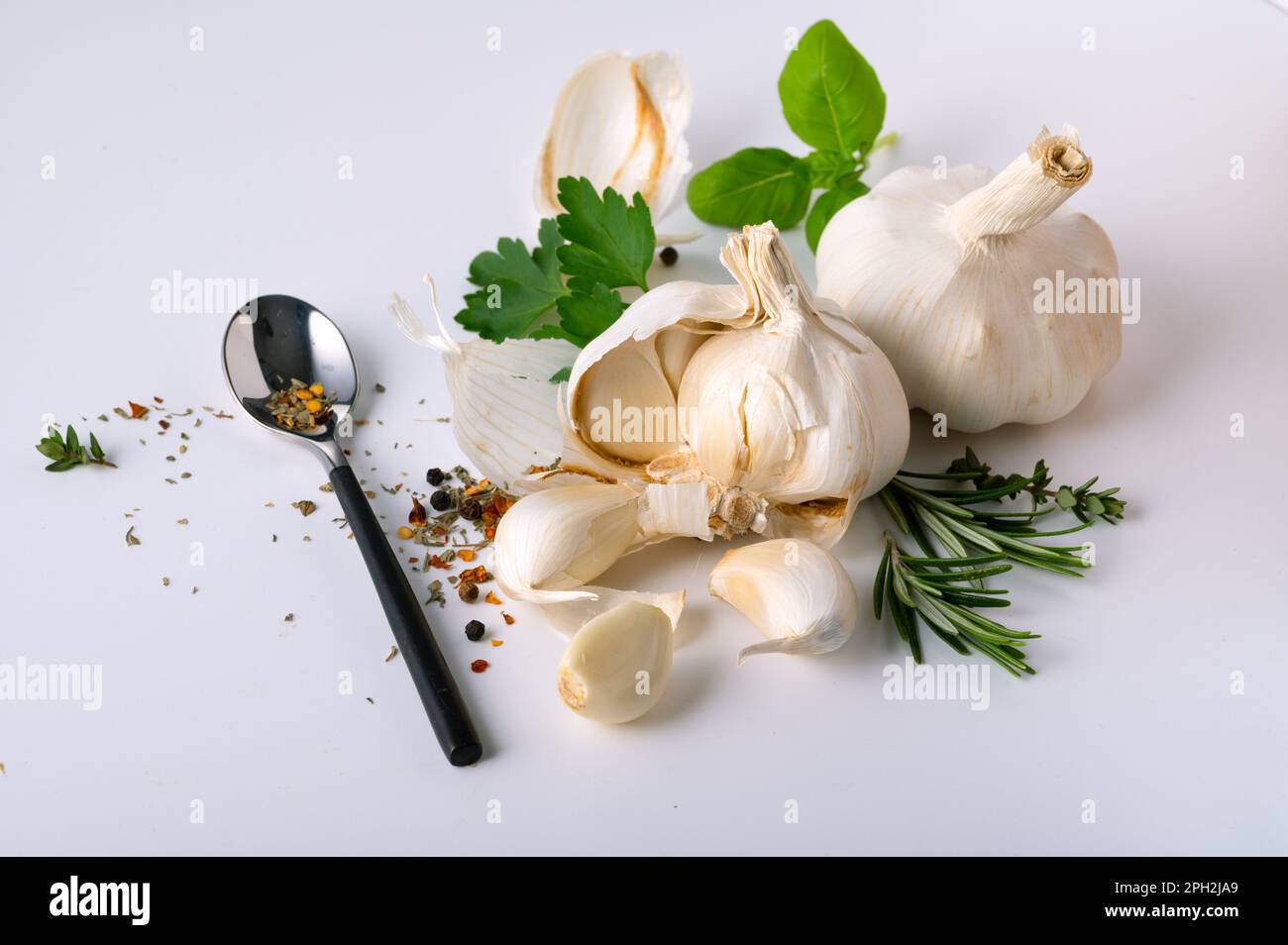 Fresh herbs with garlic and spices on white background Stock Photo - Alamy