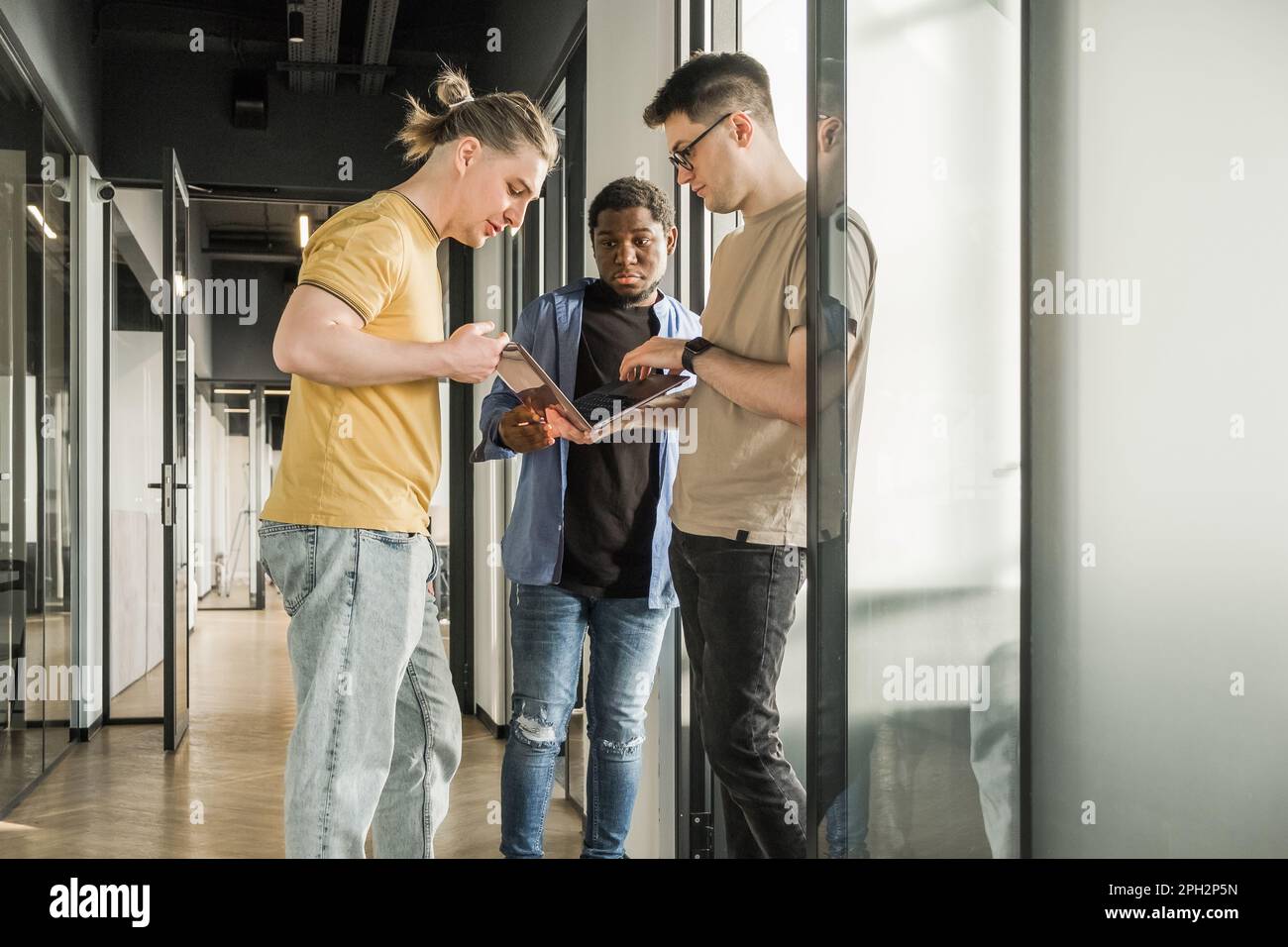 Young Developer A young developer gives new project tasks to his partners. Business ...