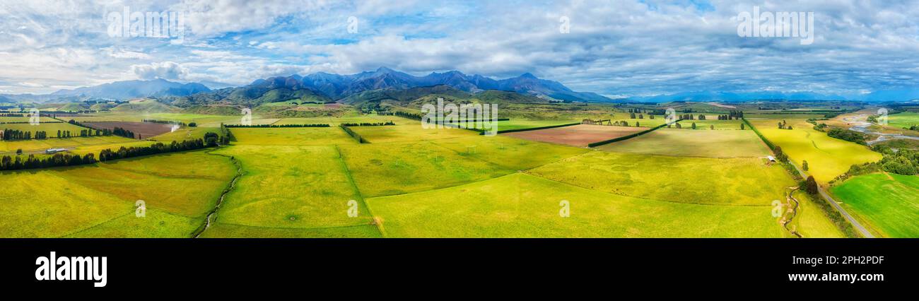 The key farm lands cultivated ship growing agriculture in New Zealand near Brunel peaks mountains. Stock Photo
