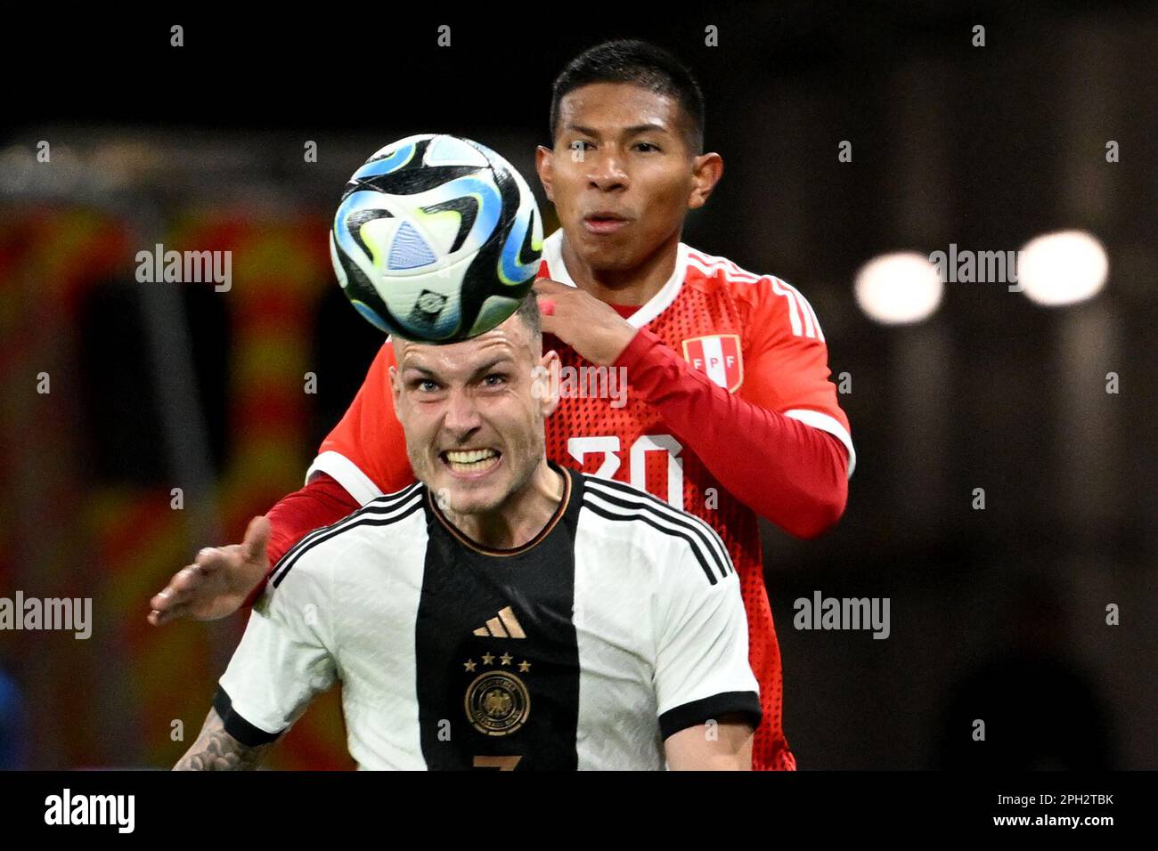 Mainz, Germany. 25th Mar, 2023. Soccer: Internationals, Germany - Peru, Mewa Arena. Germany's David Raum (front) and Peru's Edison Flores fight for the ball. Credit: Federico Gambarini/dpa/Alamy Live News Stock Photo
