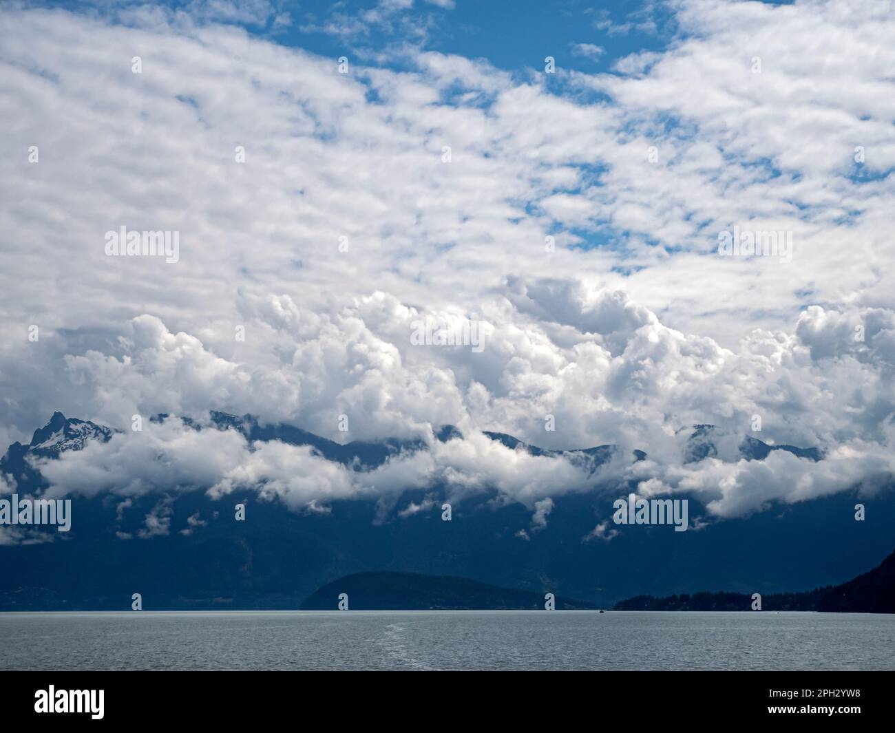 BC00746-00...BRITISH COLUMBIA - Clouds over the Coast Range from the Strait of Georgia. Stock Photo
