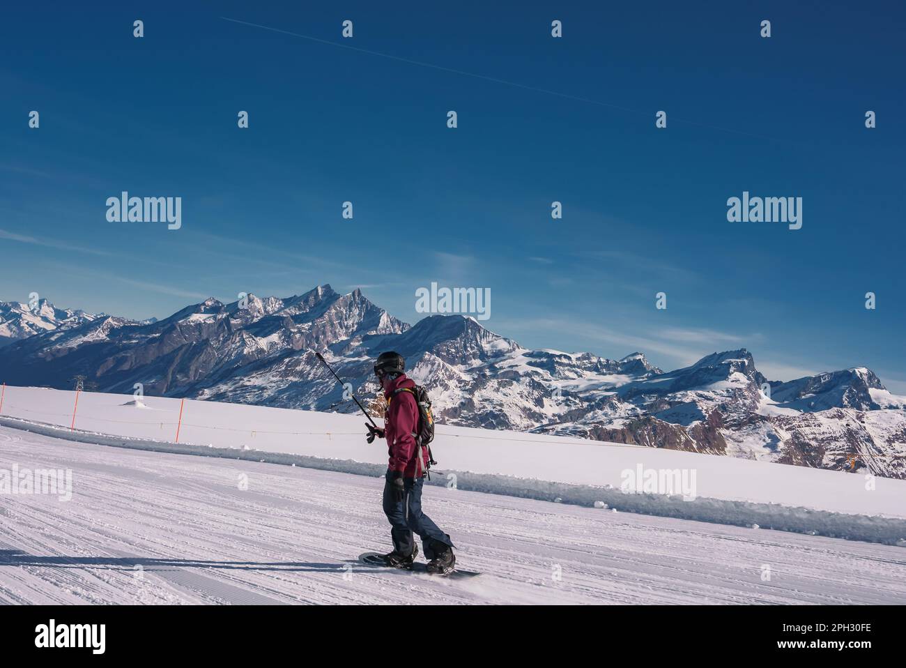 Young man snowboarding in Zermatt ski resort right next to the famous