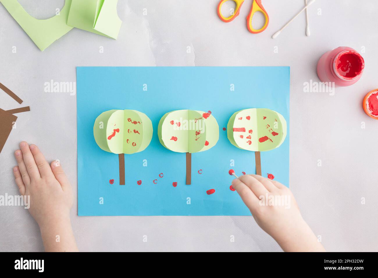 simple kids paper craft painting apple tree with cotton buds Stock