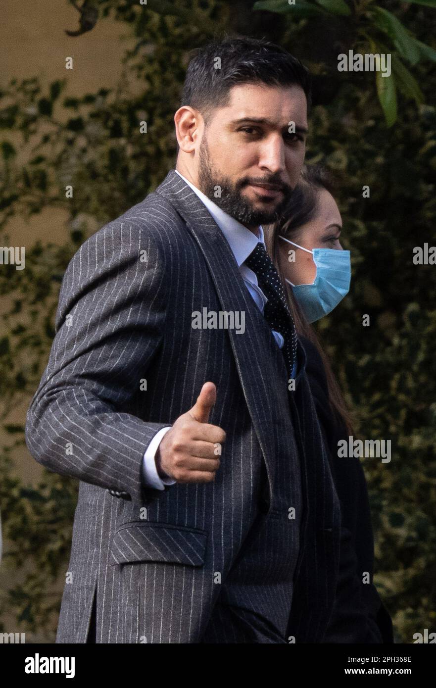 File photo dated 14/03/23 of former world boxing champion Amir Khan, gives a thumbs up as he arrives at Snaresbrook Crown Court, in east London. Mr Khan feared his 'kids would grow up without their dad' during the gunpoint robbery of his £70,000 diamond-encrusted watch. The 2004 Olympic silver medallist, 36, was targeted as he and his wife, Faryal Makhdoom, 31, left the Sahara Grill restaurant in Leyton, east London, on April 18 last year. Issue date: Saturday March 25, 2023. Stock Photo