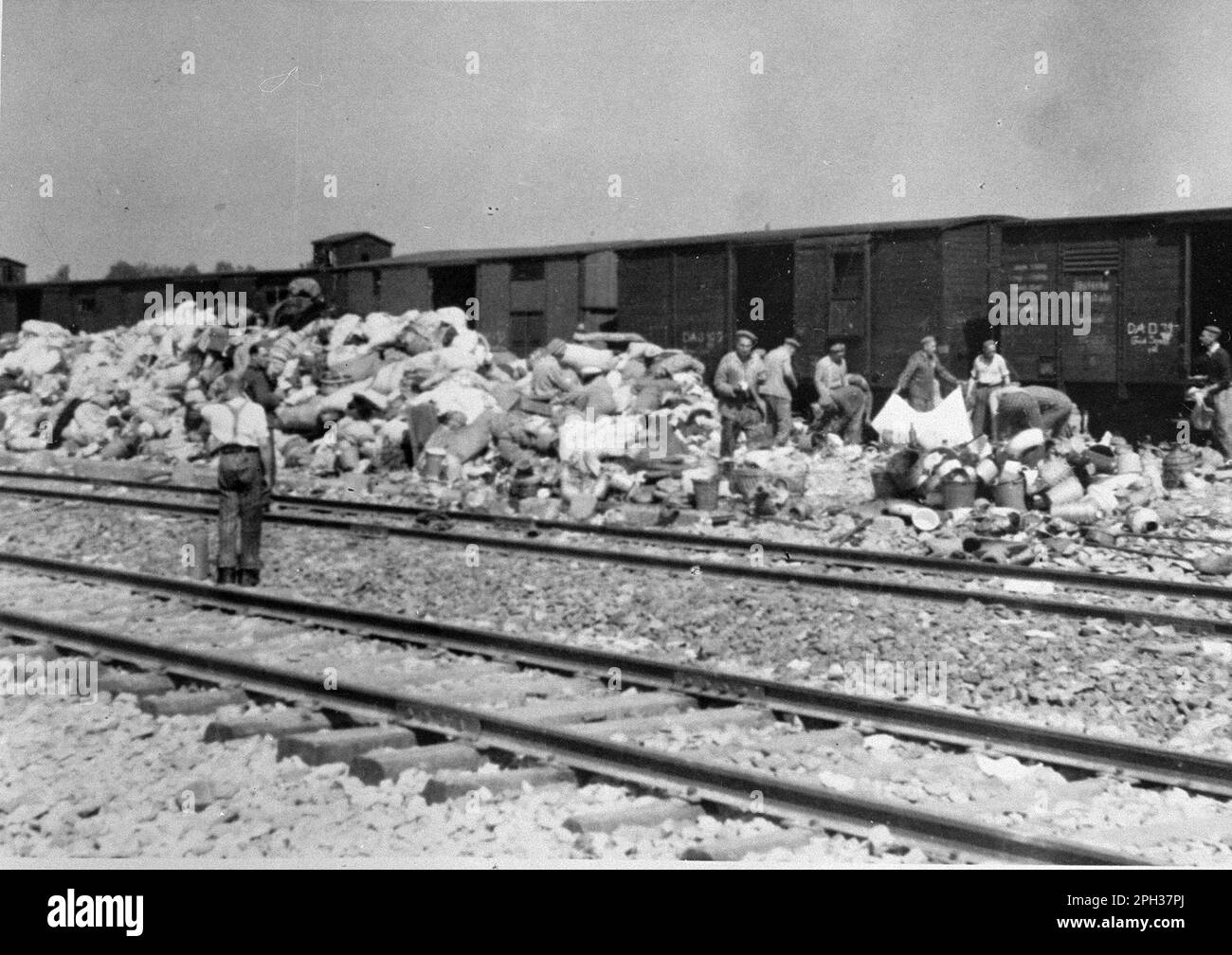 The 'Kanada' barracks in the Auschwitz concentration camp, German-occupied Poland, during the Holocaust. Prisoners sort through the cases and bags of those who were sent to the gas chamber on arrival. The warehouses were named 'Kanada' because they contained the looted belongings of prisoners and were regarded within the camp as the land of plenty. Stock Photo