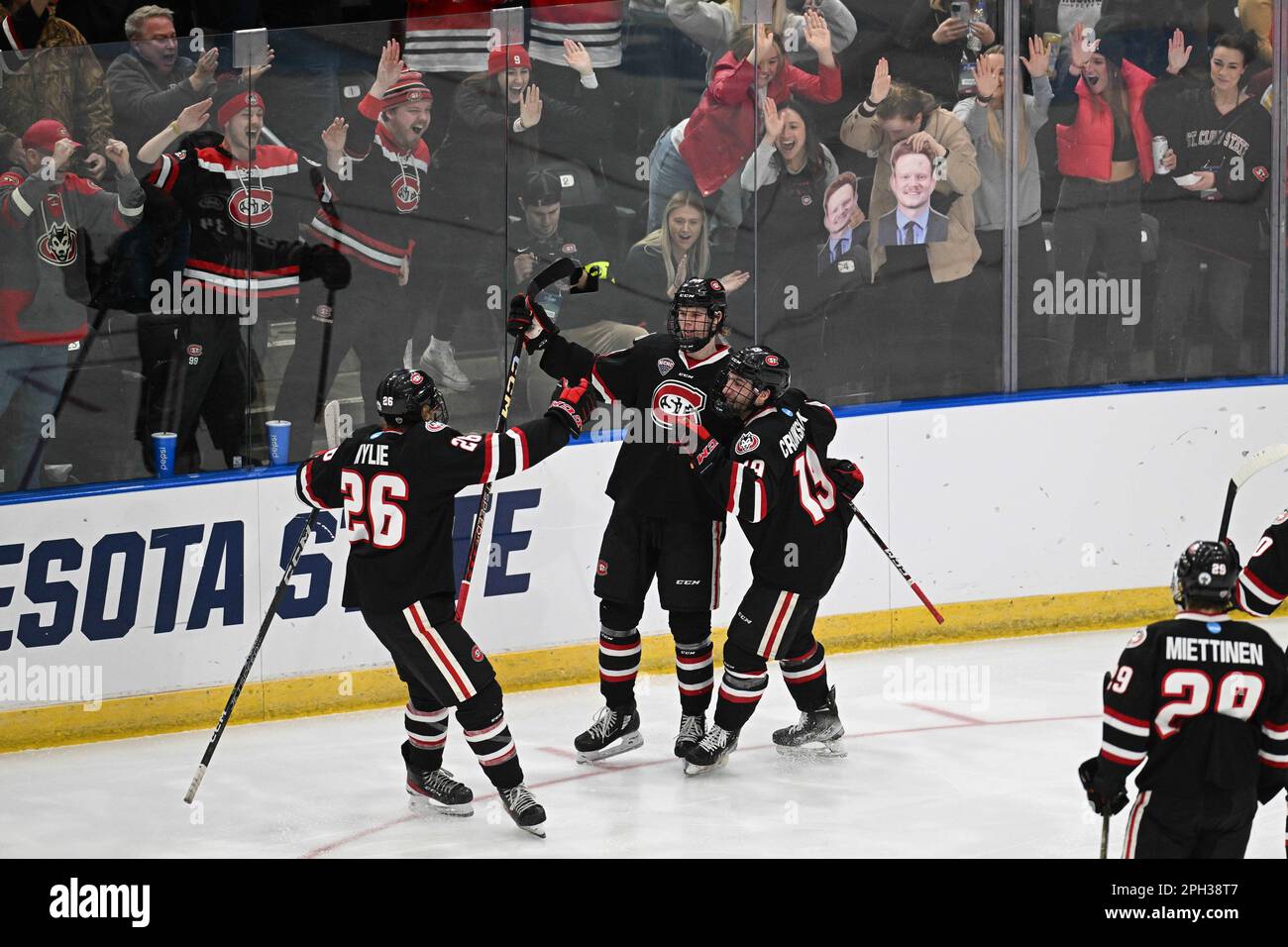 Teammates join St. Cloud State Huskies forward Adam Ingram (34) in