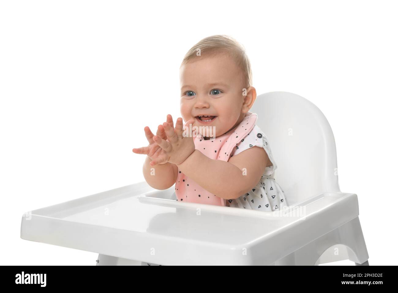 Cute little baby wearing bib in highchair on white background Stock