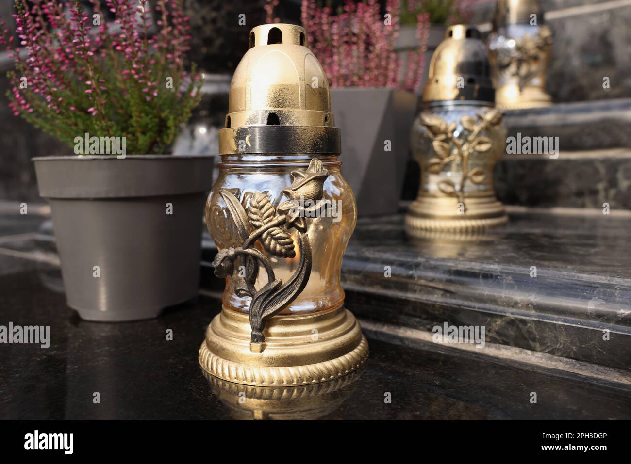 Golden grave lanterns on granite stairs at cemetery Stock Photo - Alamy