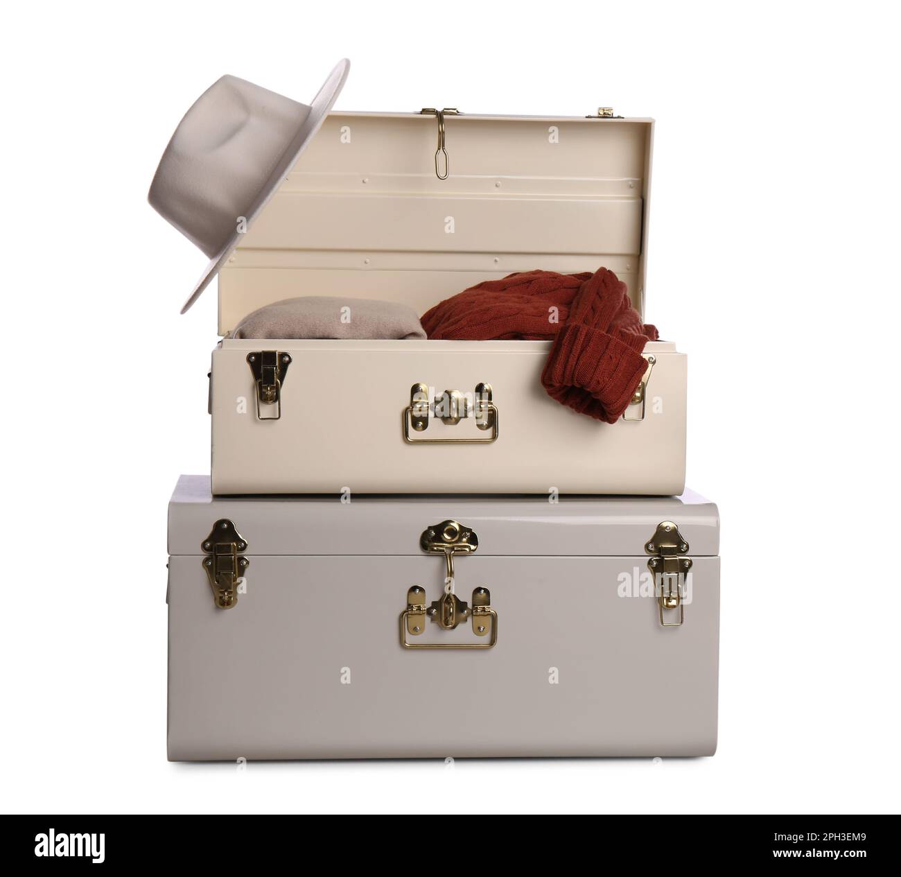 Stylish storage trunks with clothes isolated on white Stock Photo Alamy