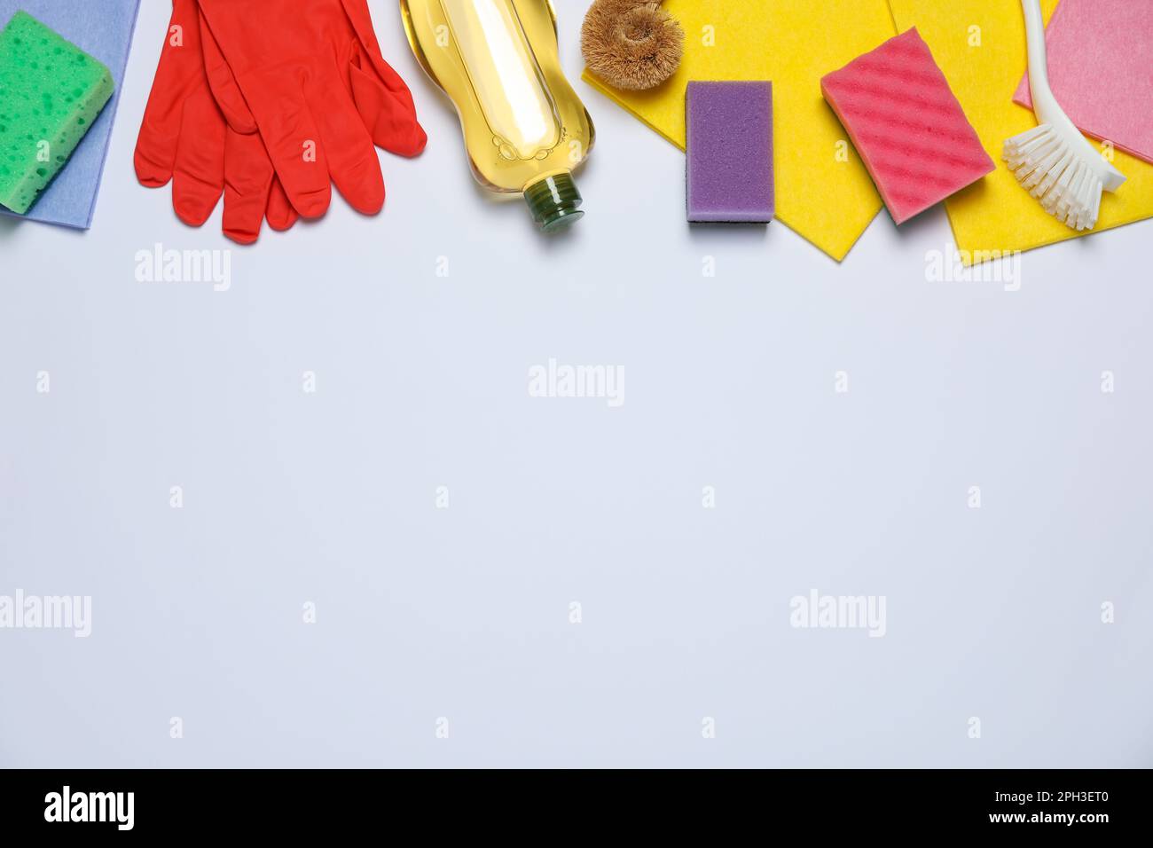 Flat lay composition with sponges and other cleaning products on white ...