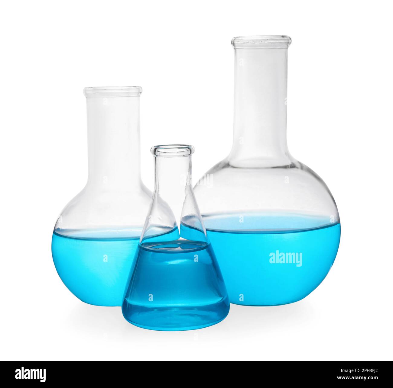 Different laboratory glassware with light blue liquid on white ...