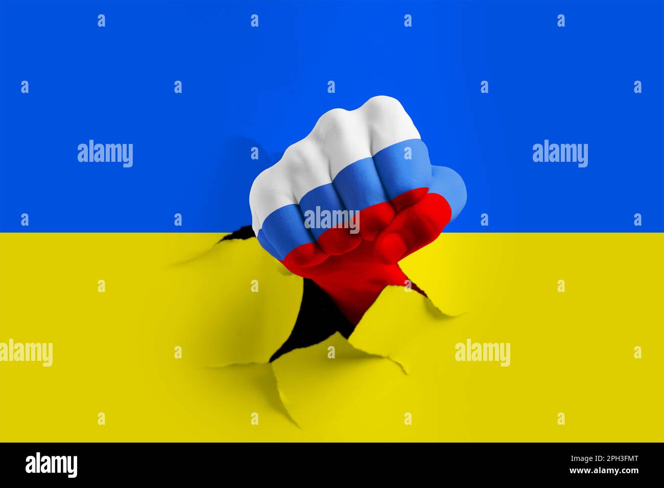 Russian invasion of Ukraine. Man breaking through paper Ukrainian flag with fist painted in colors of Russian flag Stock Photo
