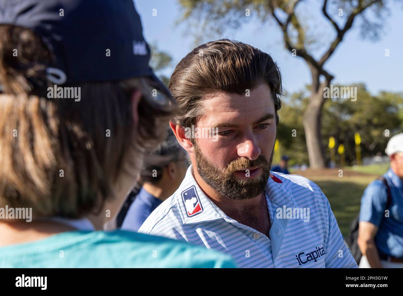 AUSTIN, TX MARCH 25 Cameron Young hands signed golf balls to the