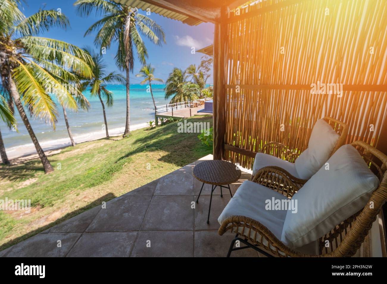 Empty terrace chair and table on blue Caribbean sea beach background Stock Photo