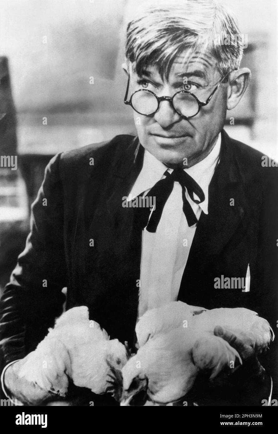 Will Rogers (1879-1935), American cowboy humorist, film star, entertainer, and writer, holding chickens in the 1930s. Stock Photo