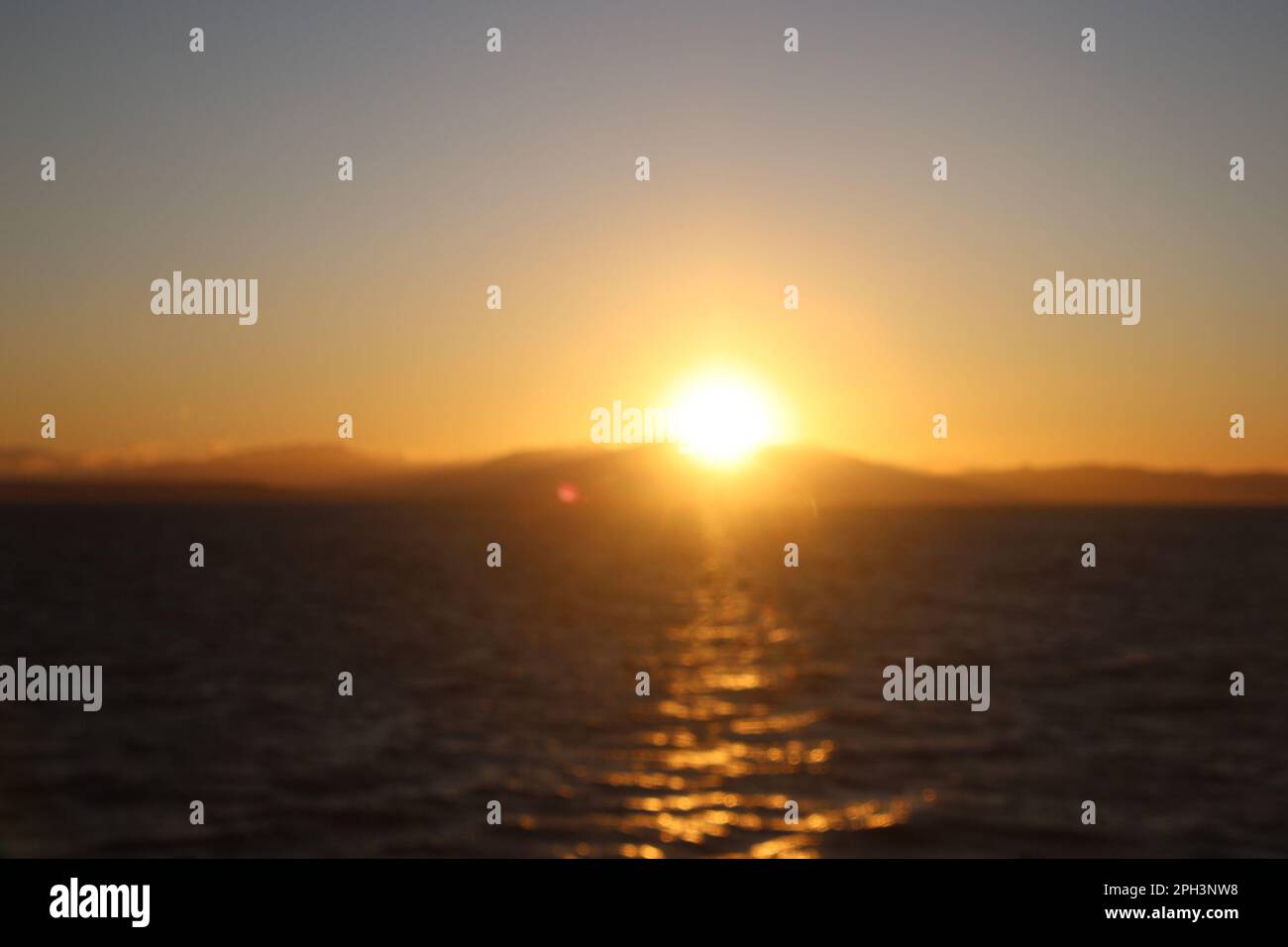 The sky turns into a canvas of warm hues as the sun emerges from the ...