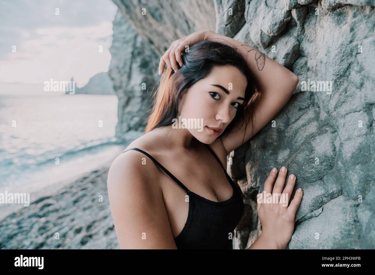Portrait of cheerful female climber resting on a volcanic basalt Stock Photo