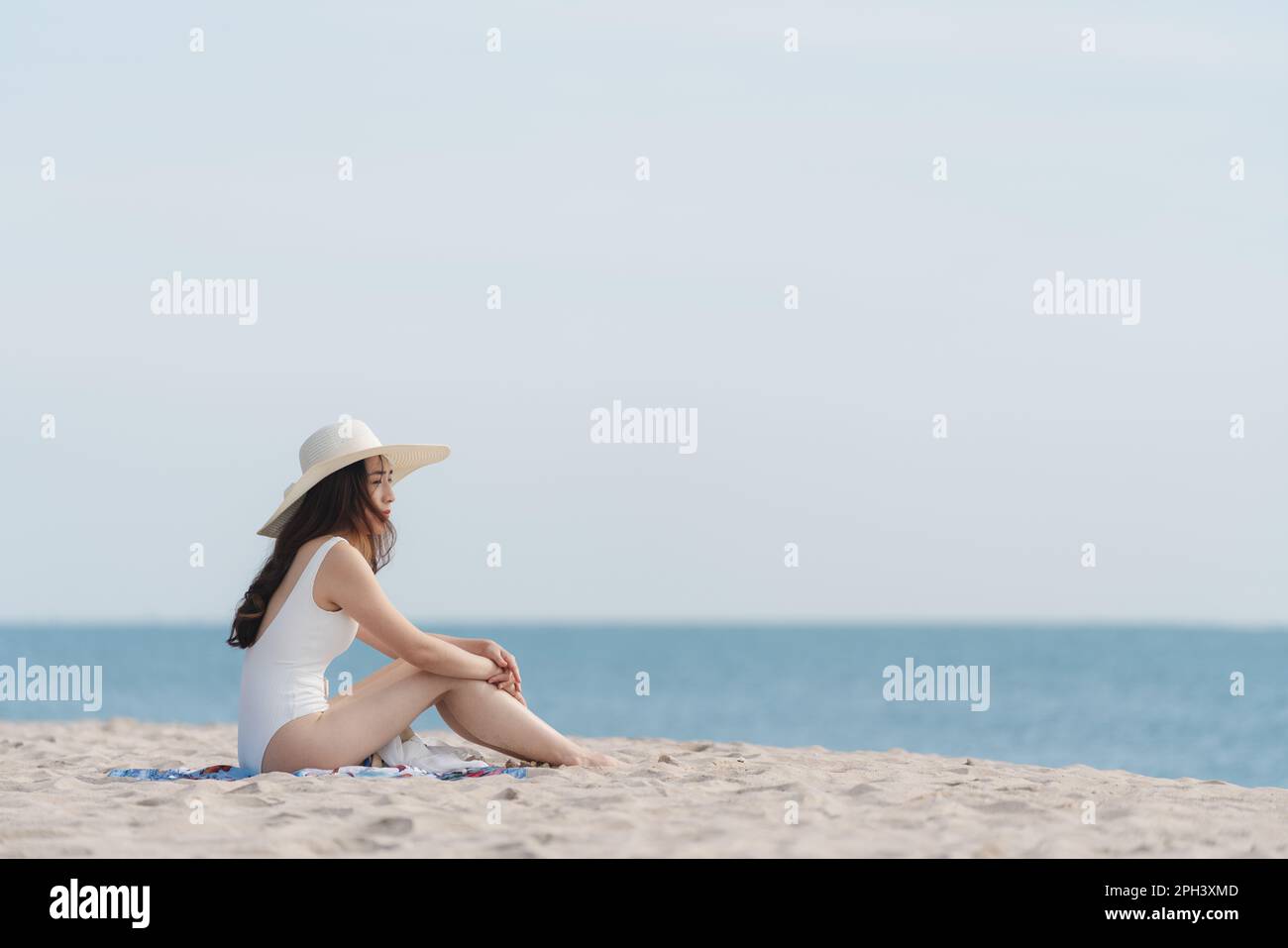Vacation on the beach, Young woman relaxing on the beach in summer Stock Photo