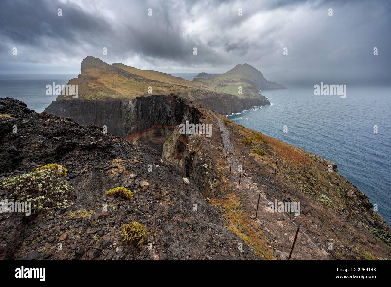 Hiking trail at the rocky promontory, coastal landscape, steep cliffs 
